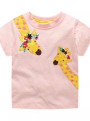 Front view of a blush pink children's short sleeve t shirt with two yellow giraffe appliques