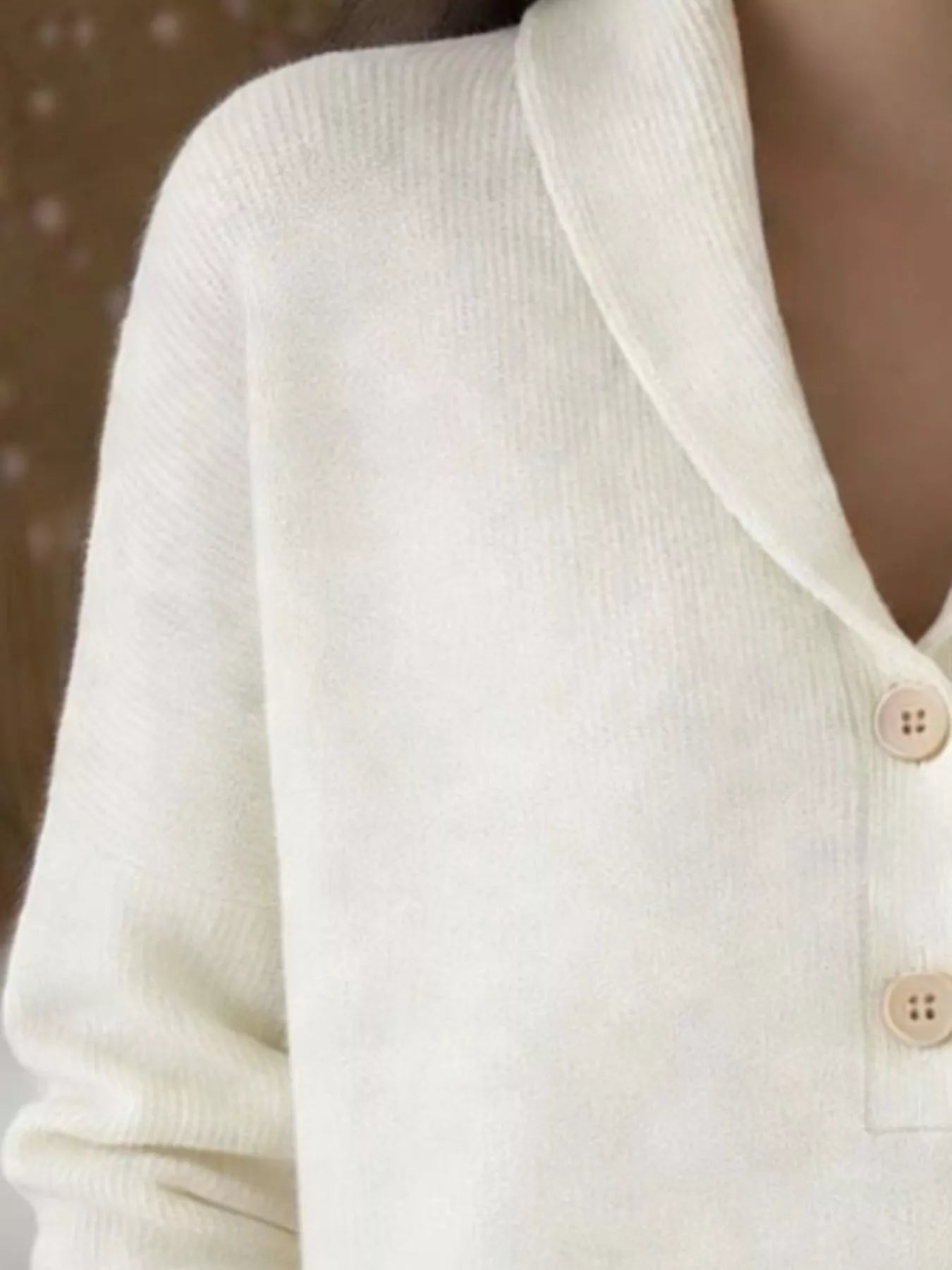 Closer on-model front view of the cream shawl collar sweater with button placket