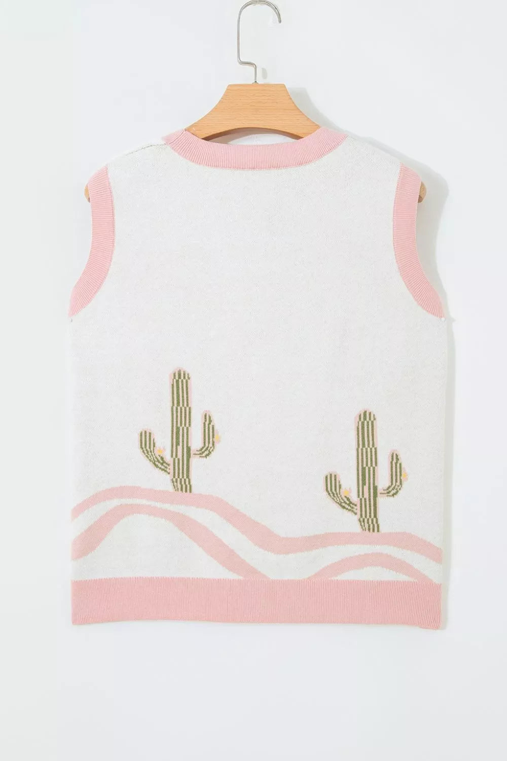 Back view of the cream cactus sweater vest with pink trim hanging on a hanger