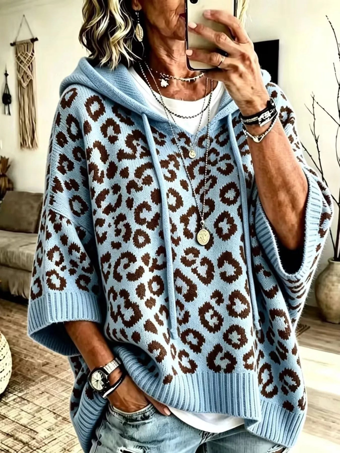Light blue leopard print oversized hooded knit sweater with drawstrings, front angle view