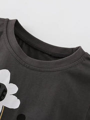 Close-up of the dark gray shirt neckline with ribbed trim and part of the flower graphic