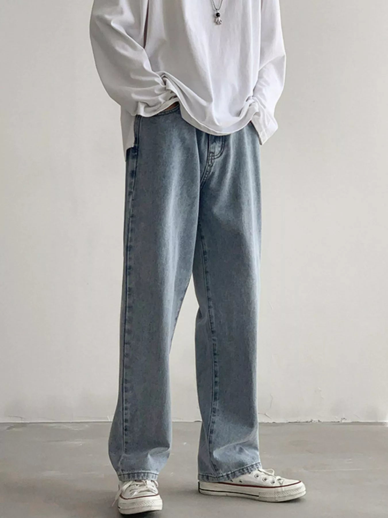 Men's Air Force Blue loose fit wash jeans on model, front view with hands in pockets.