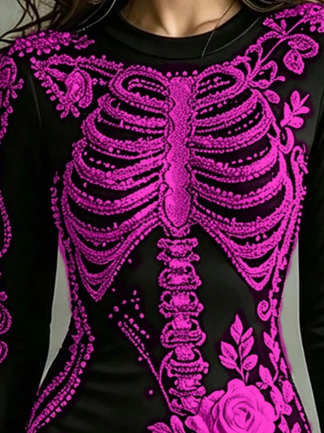 Close detail of magenta skeleton print on black long sleeve bodycon dress bodice