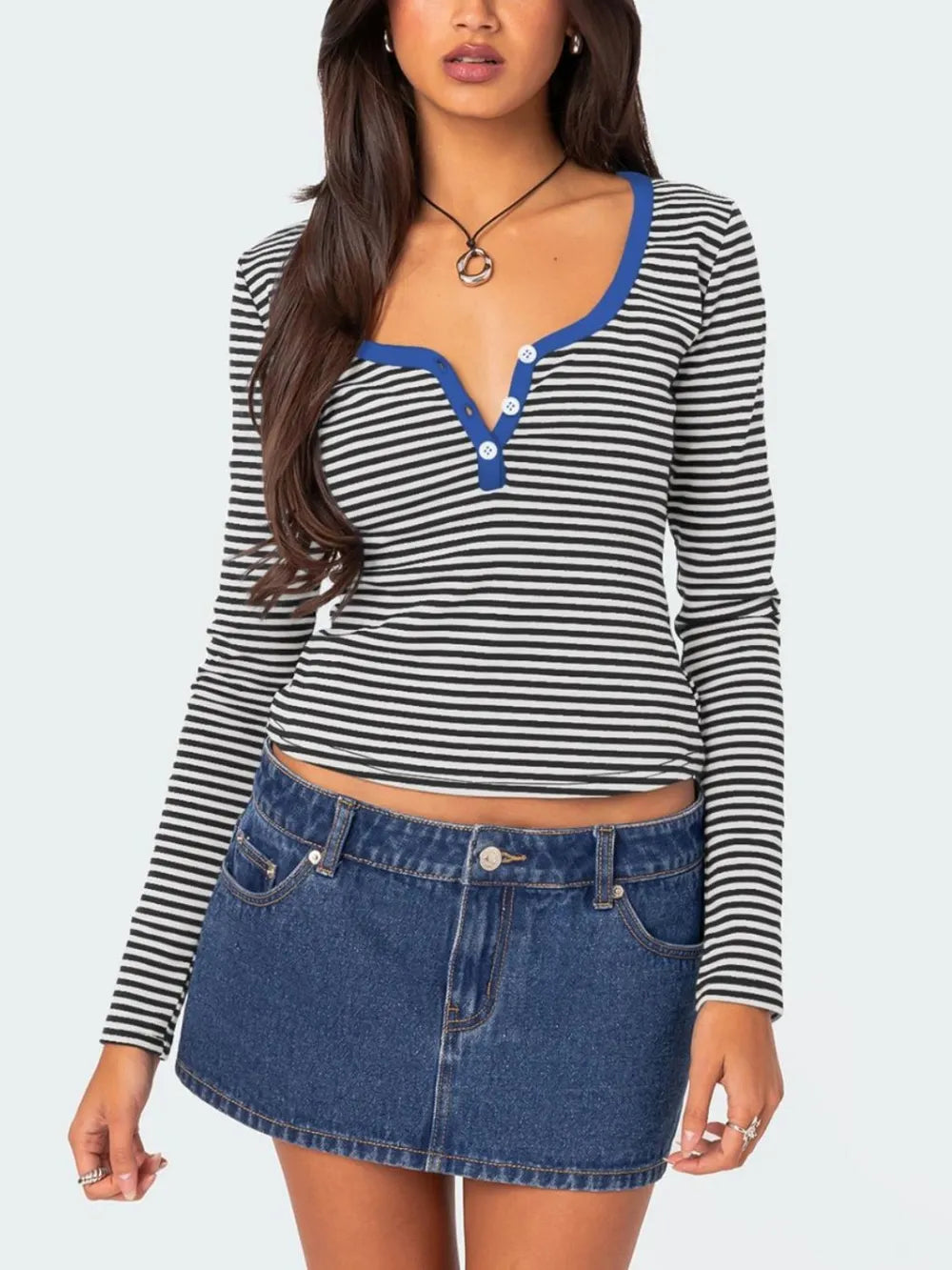 Black and white striped long sleeve t shirt with royal blue trim and white buttons worn on model front view