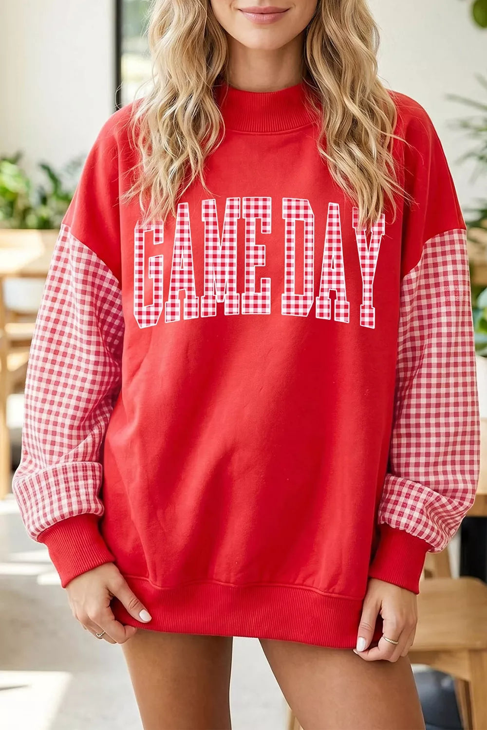 Red mock neck sweatshirt with red and white plaid sleeves and GAME DAY lettering, front view