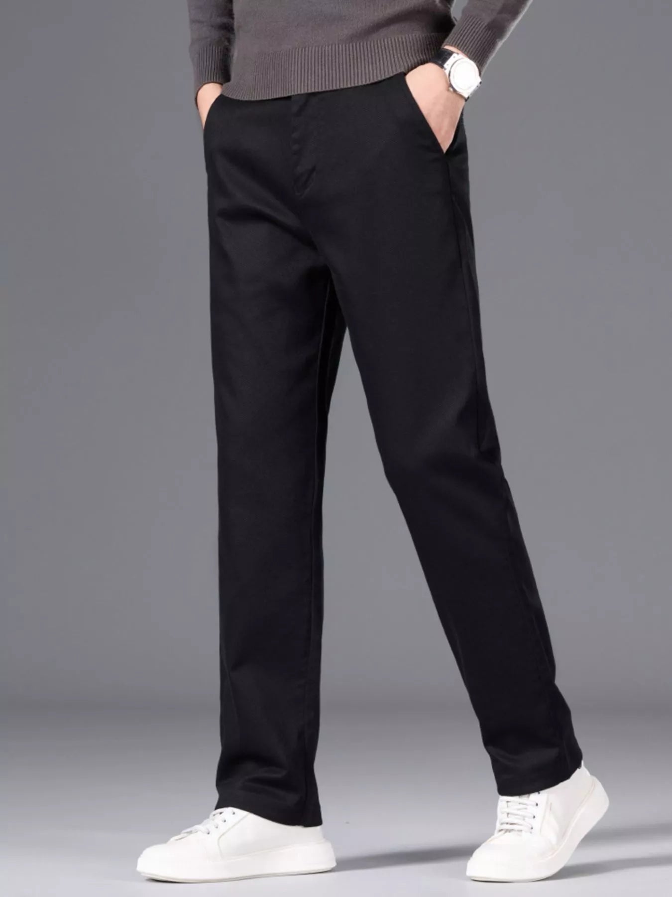 Men's black slim-fit pants made from cotton with pockets.