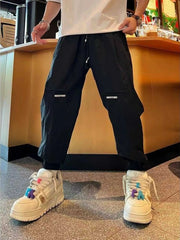 Men's black cotton-blend joggers with a drawstring waist and pockets.