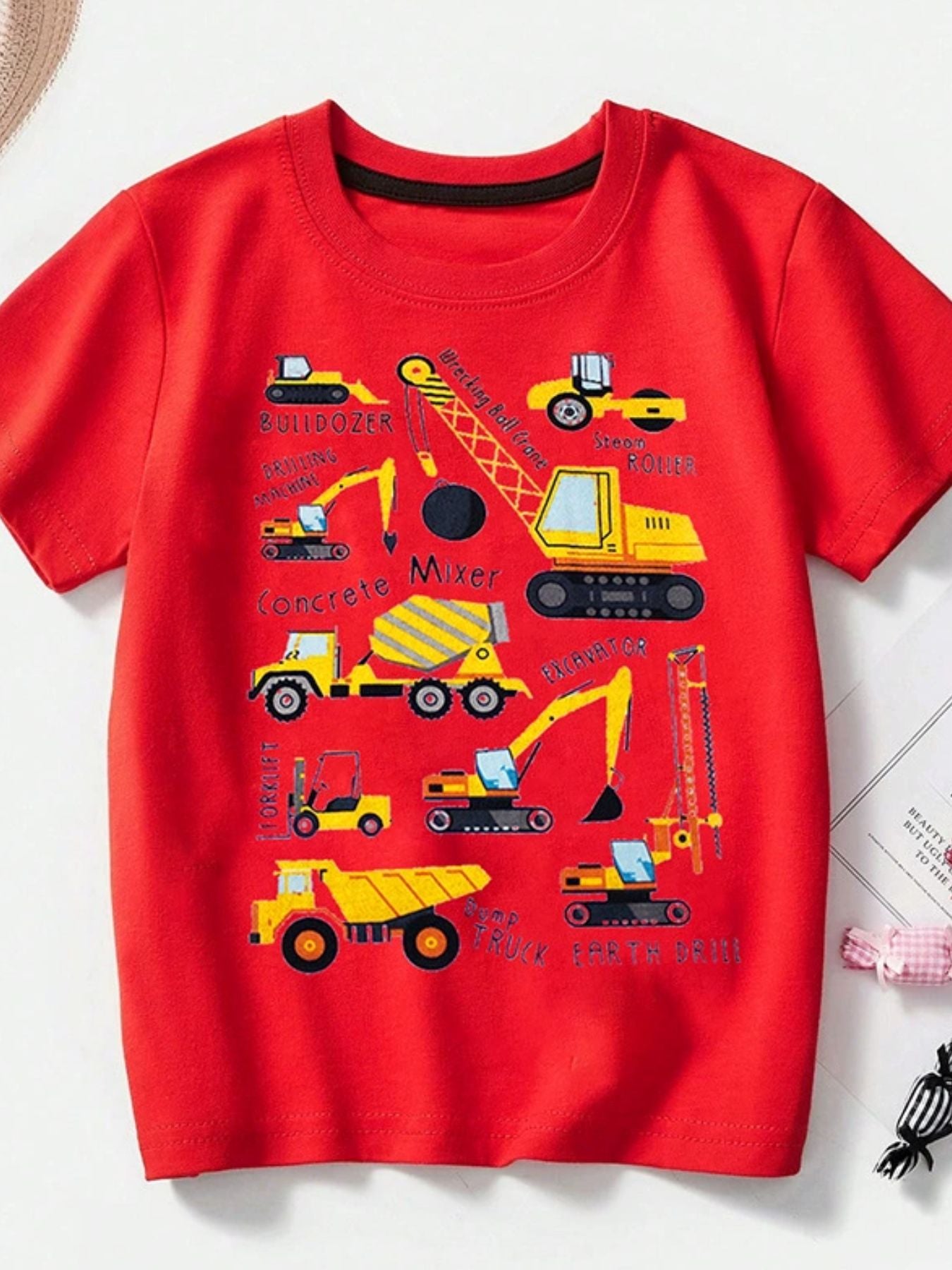 Red children's crew neck short sleeve T-shirt with labeled construction vehicle graphics, laid flat in front view