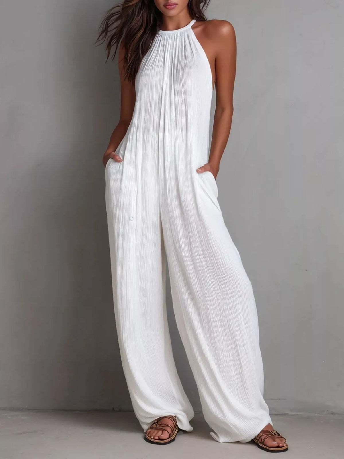 Women's sleeveless wide-leg jumpsuit with pockets and a zipper closure.