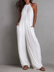 Women's sleeveless wide-leg jumpsuit with pockets and a zipper closure.