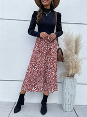 Women's printed midi dress with a mock neckline and puff sleeves.