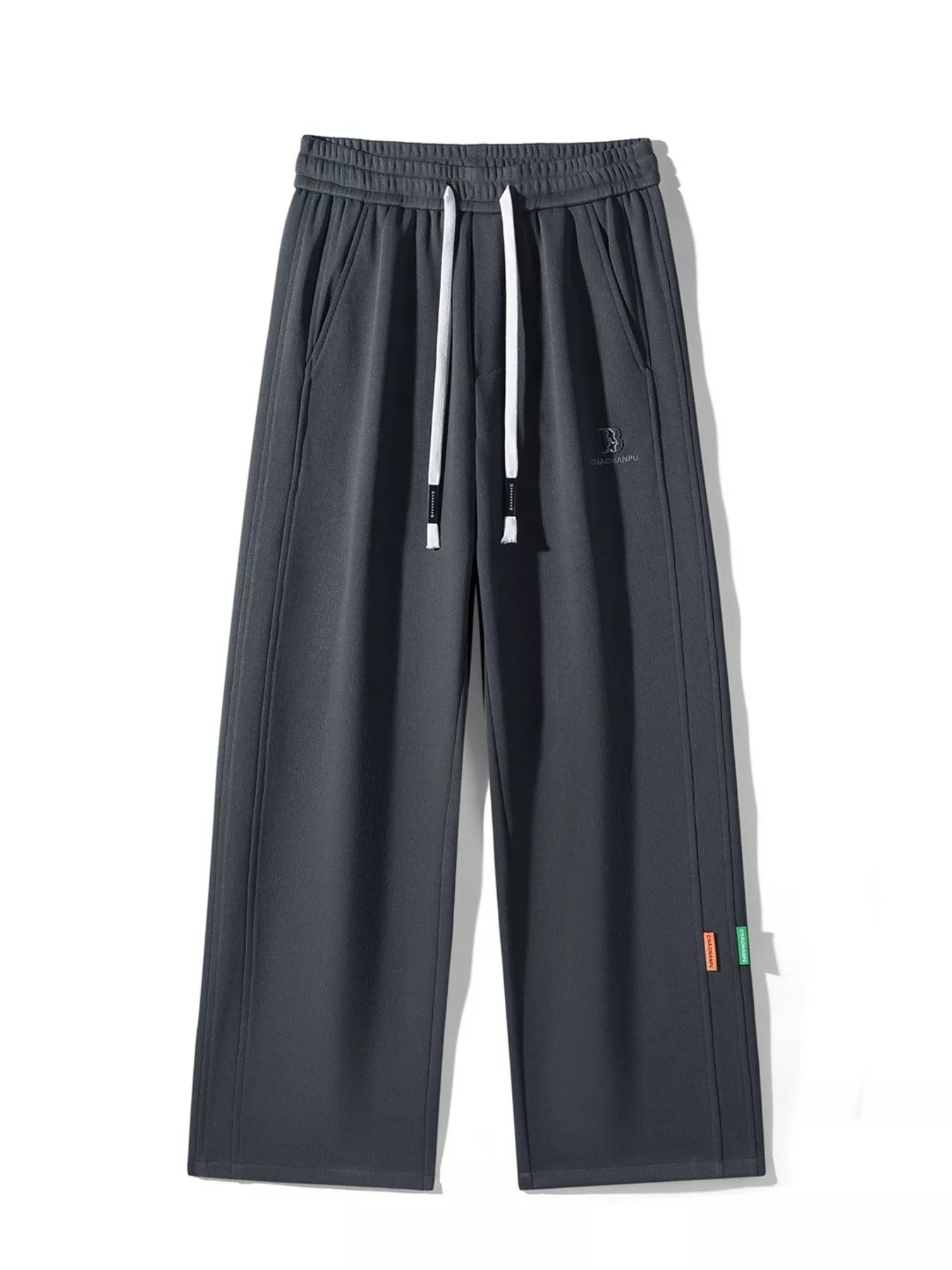 Men's casual loose fit pants with a drawstring waist and pockets.