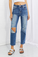 Women's high-rise relaxed jeans with cropped legs and distressed knees.