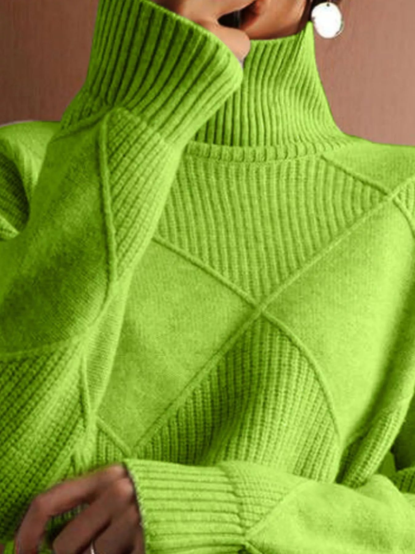 Close up of the bright green ribbed turtleneck and diamond knit pattern