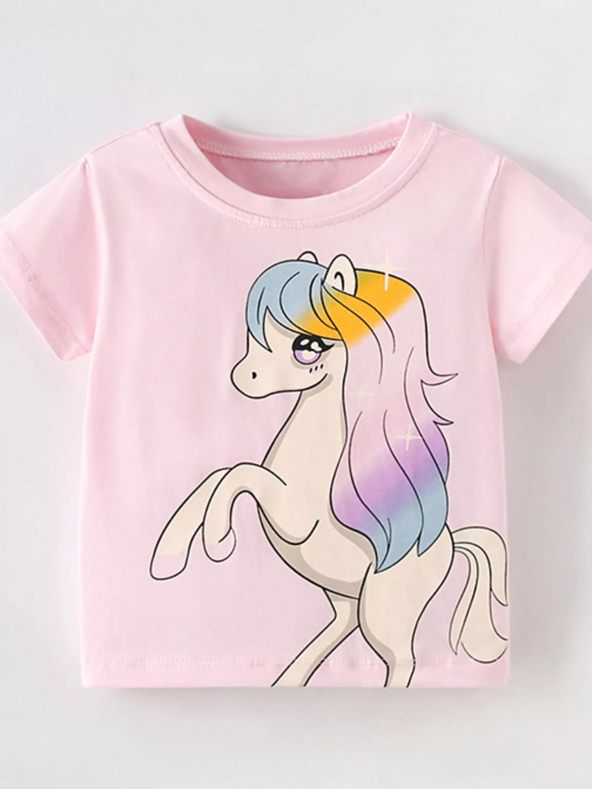 Blush pink children's short sleeve t-shirt with large unicorn and rainbow mane graphic, front flat view