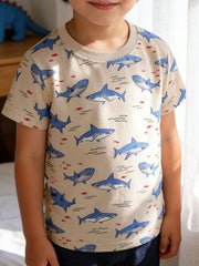 Front view of a children's crew neck t-shirt with blue shark and red fish print on beige fabric