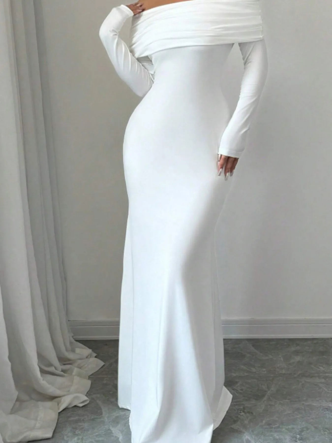 Side view of white off shoulder bodycon maxi dress showing the long skirt