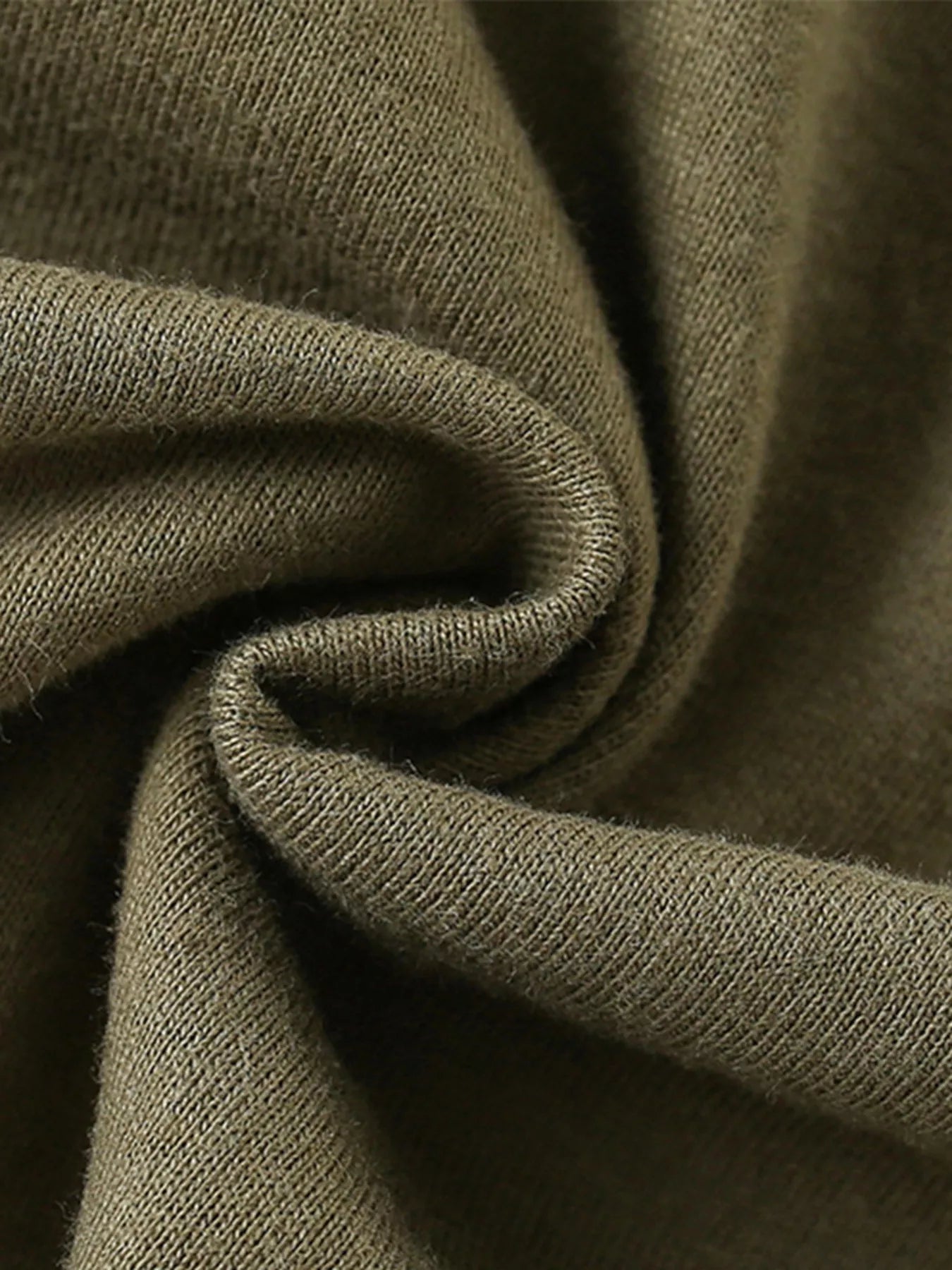 Close-up texture of the soft army green fabric of the children's raglan shirt