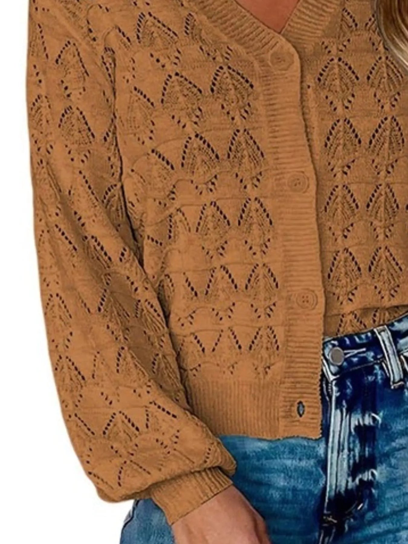 Side close view of brown openwork knit cardigan showing button front and hem.