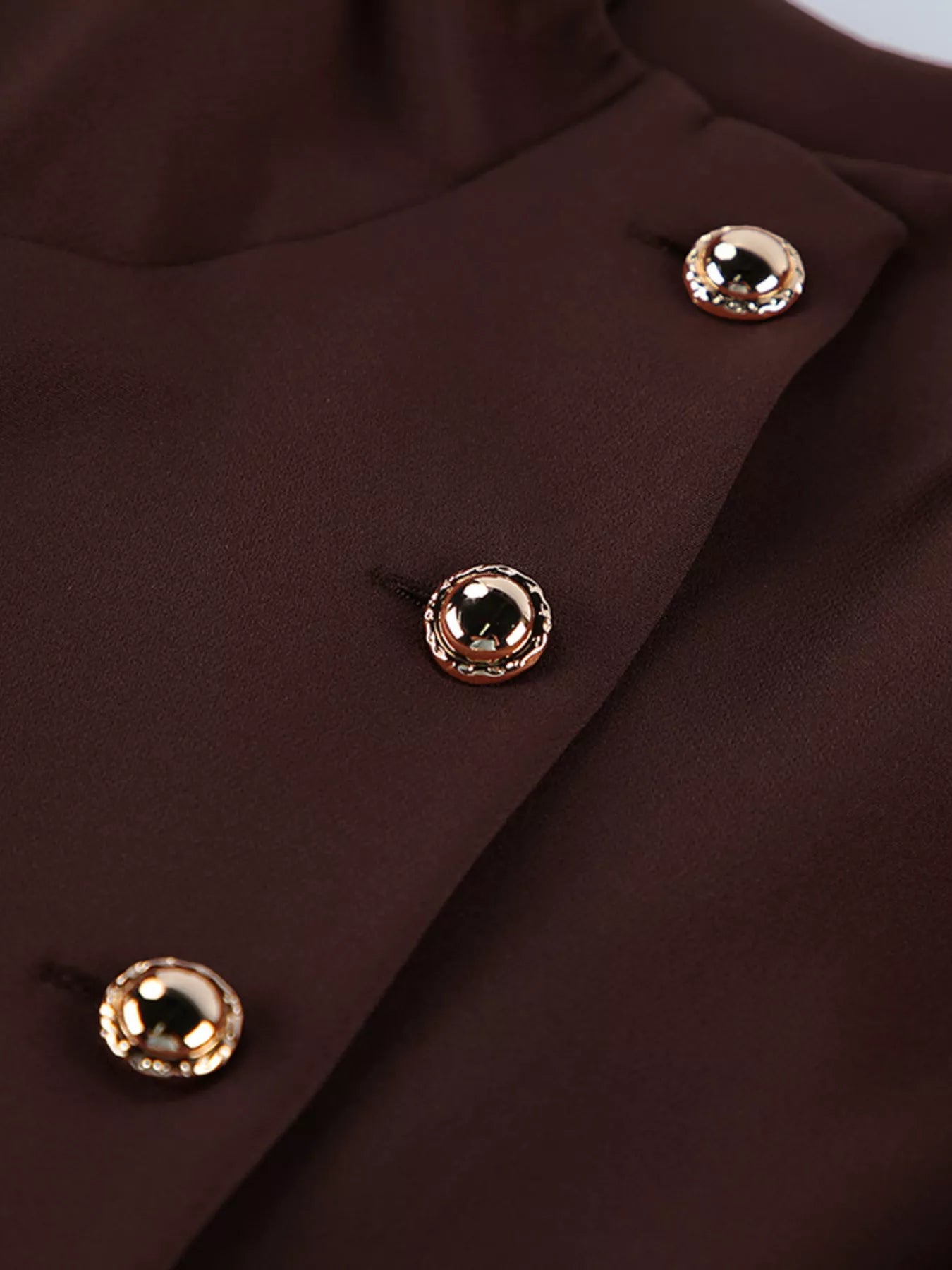 Brown button down mini dress detail showing gold dome buttons on placket close