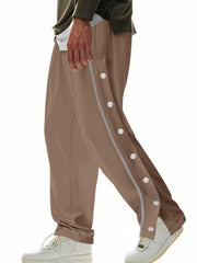 Men's brown loose-fit track pants with side snap buttons and pockets.