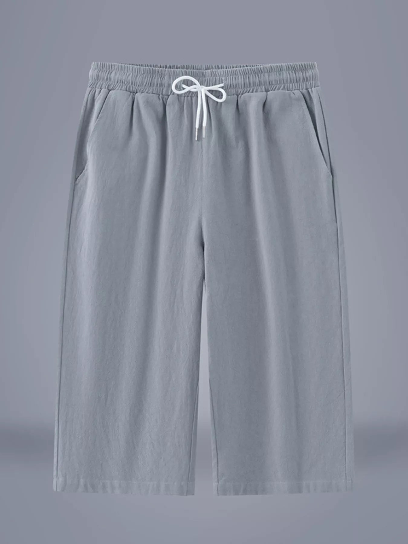 Men's light gray cropped casual pants with a drawstring waist and pockets.