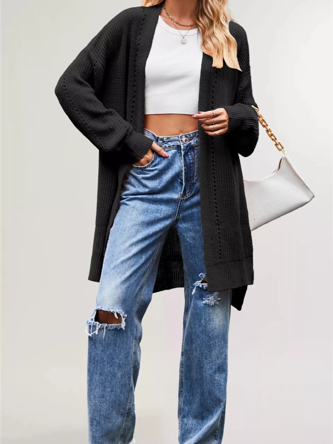 Front view of the black long open front cardigan with openwork stripes
