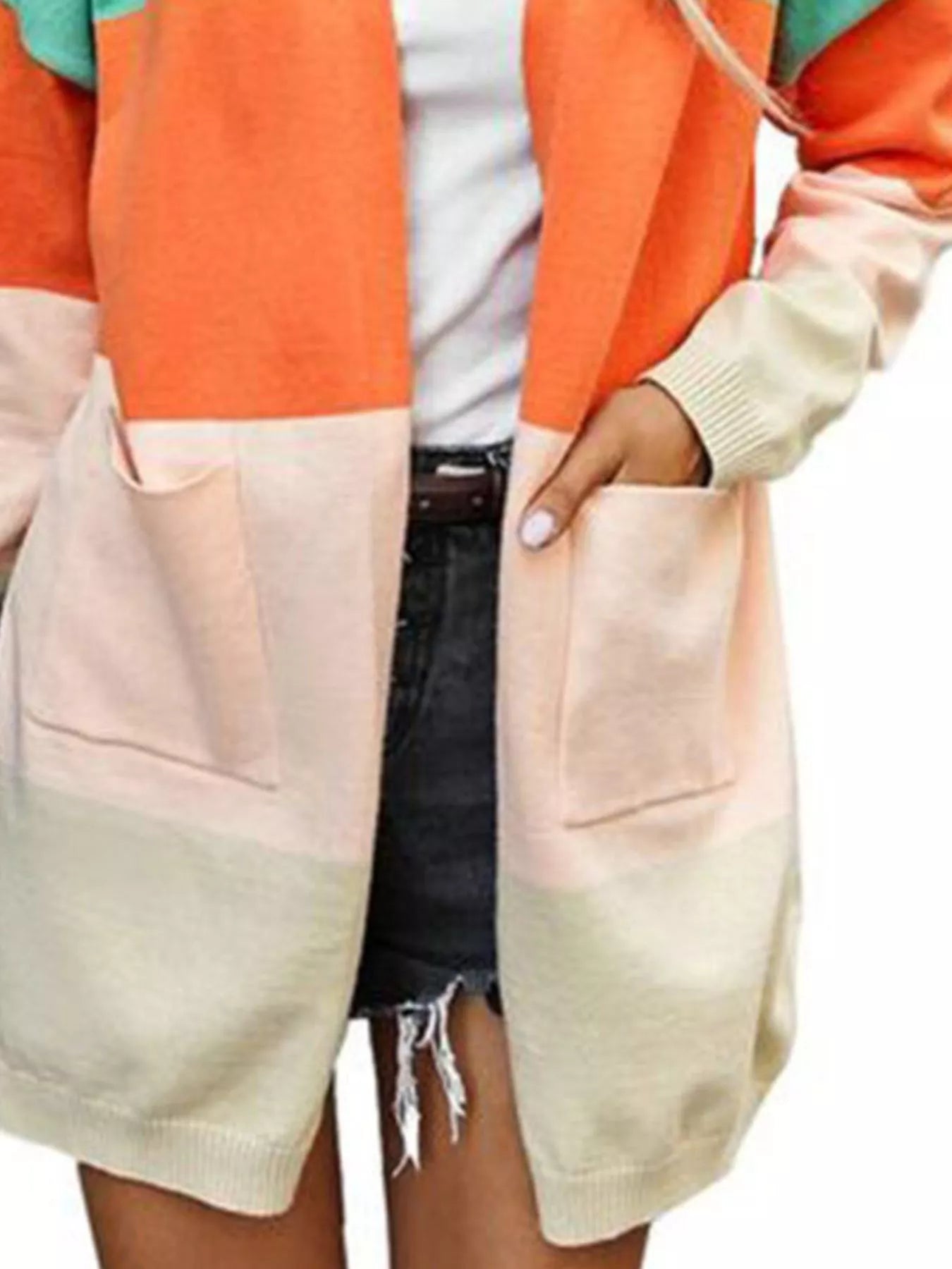 Close up of color block cardigan pockets with pink and cream panels