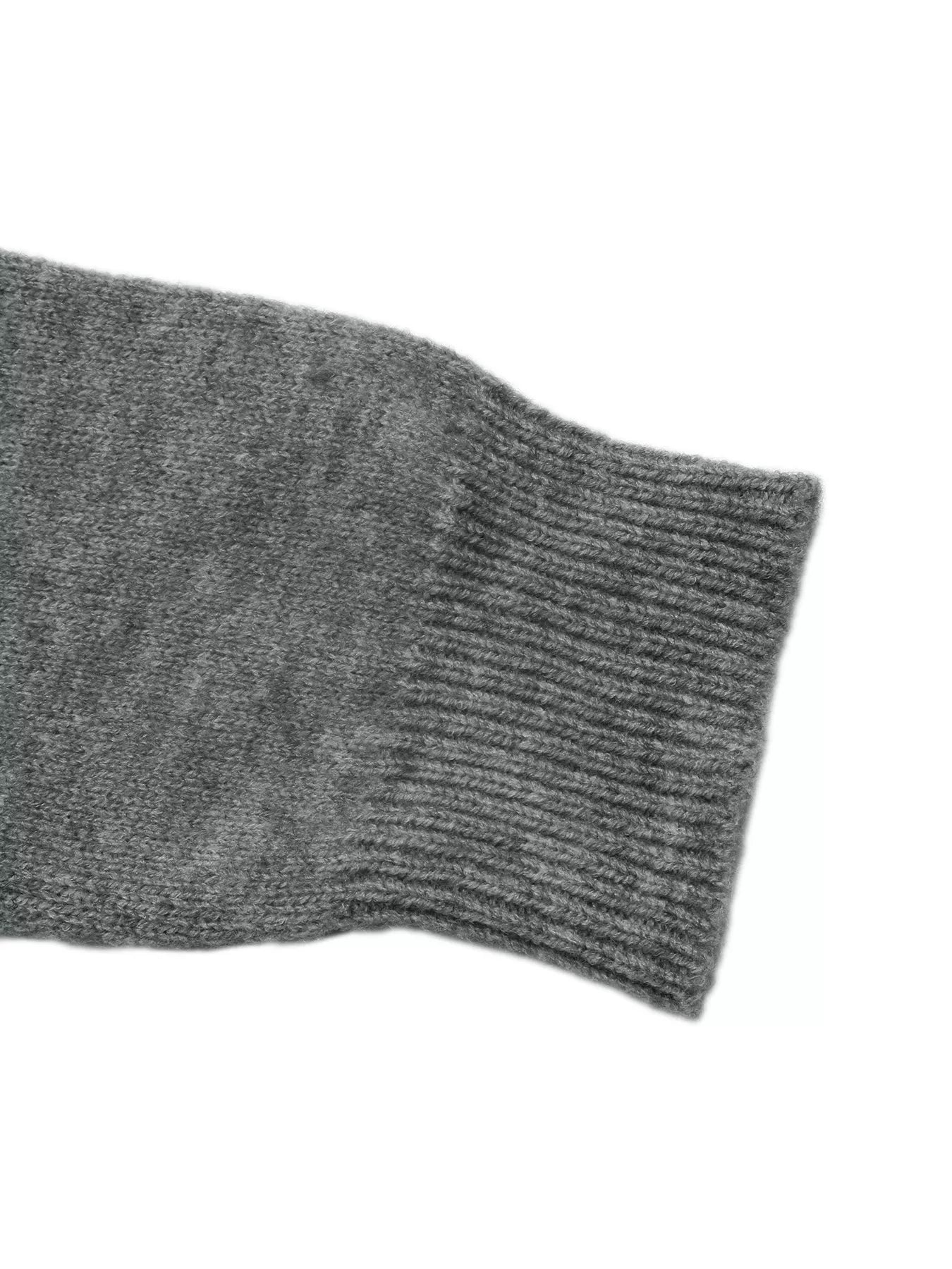 Close-up of a ribbed gray sweater cuff on a long knit sleeve
