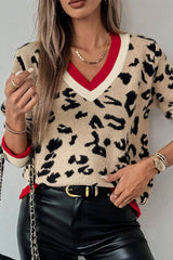 Front view of beige leopard knit sweater with contrast red and cream ribbed cuffs.
