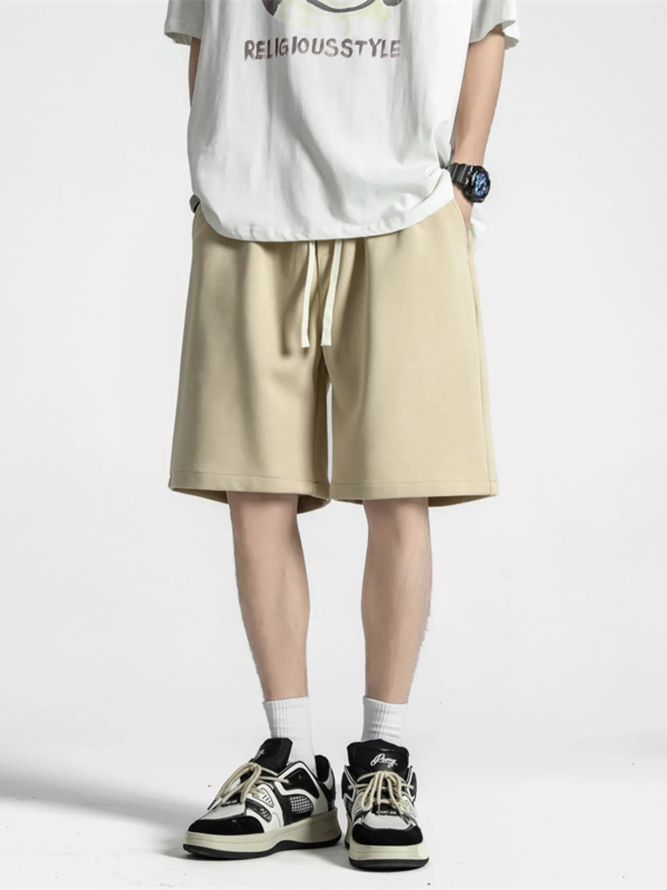Men's khaki loose-fit casual shorts with a drawstring waist.