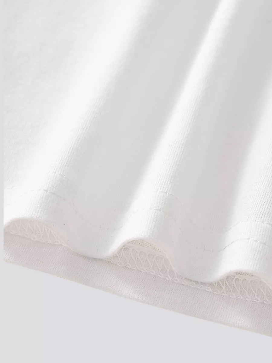 Close up of the white bottom hem showing fine stitching and overlock detail