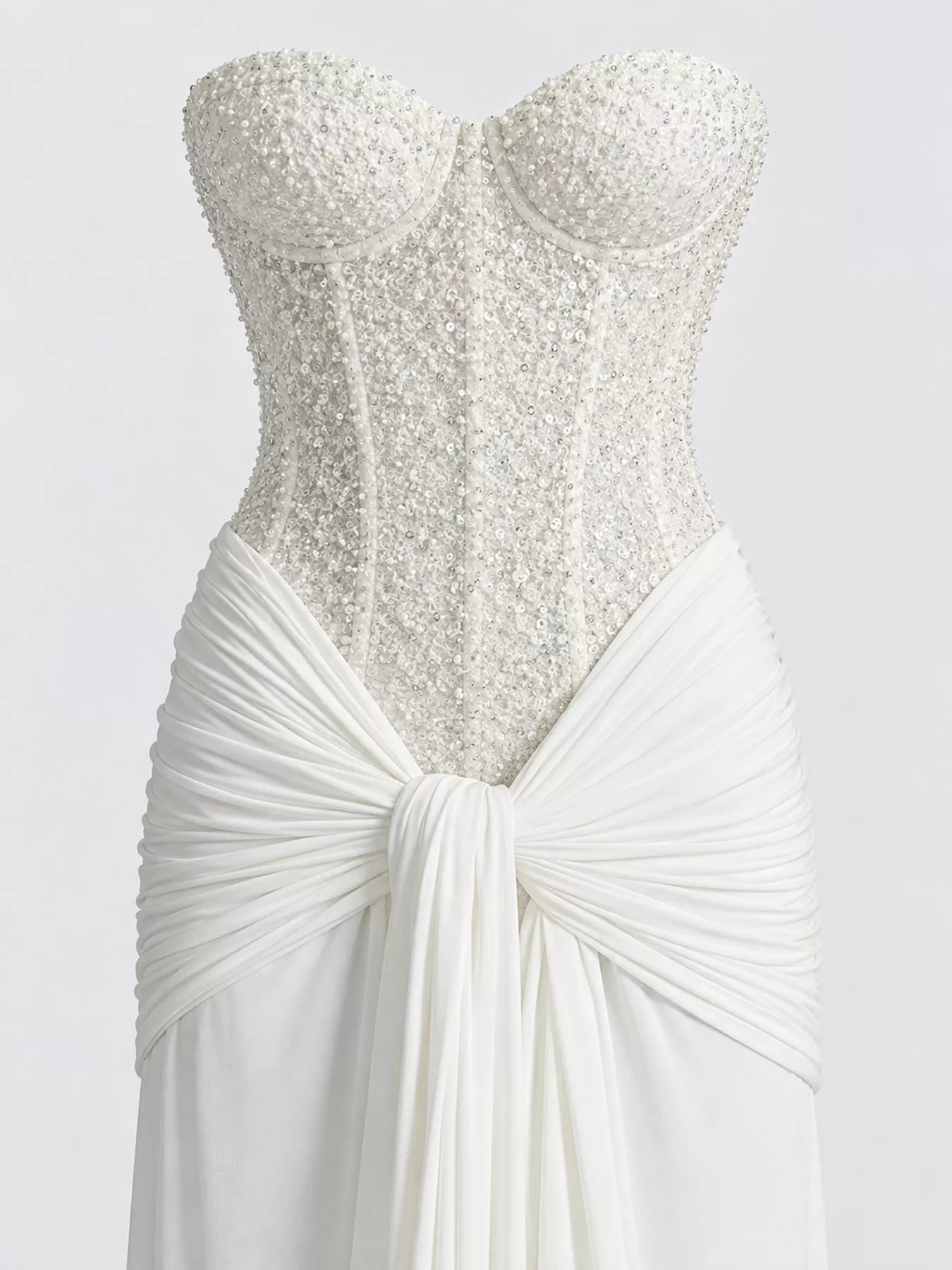 White strapless sequin corset bodice and knotted draped waist, close detail view