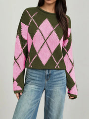 On-model front view of the olive and pink argyle sweater showing the long dropped sleeves