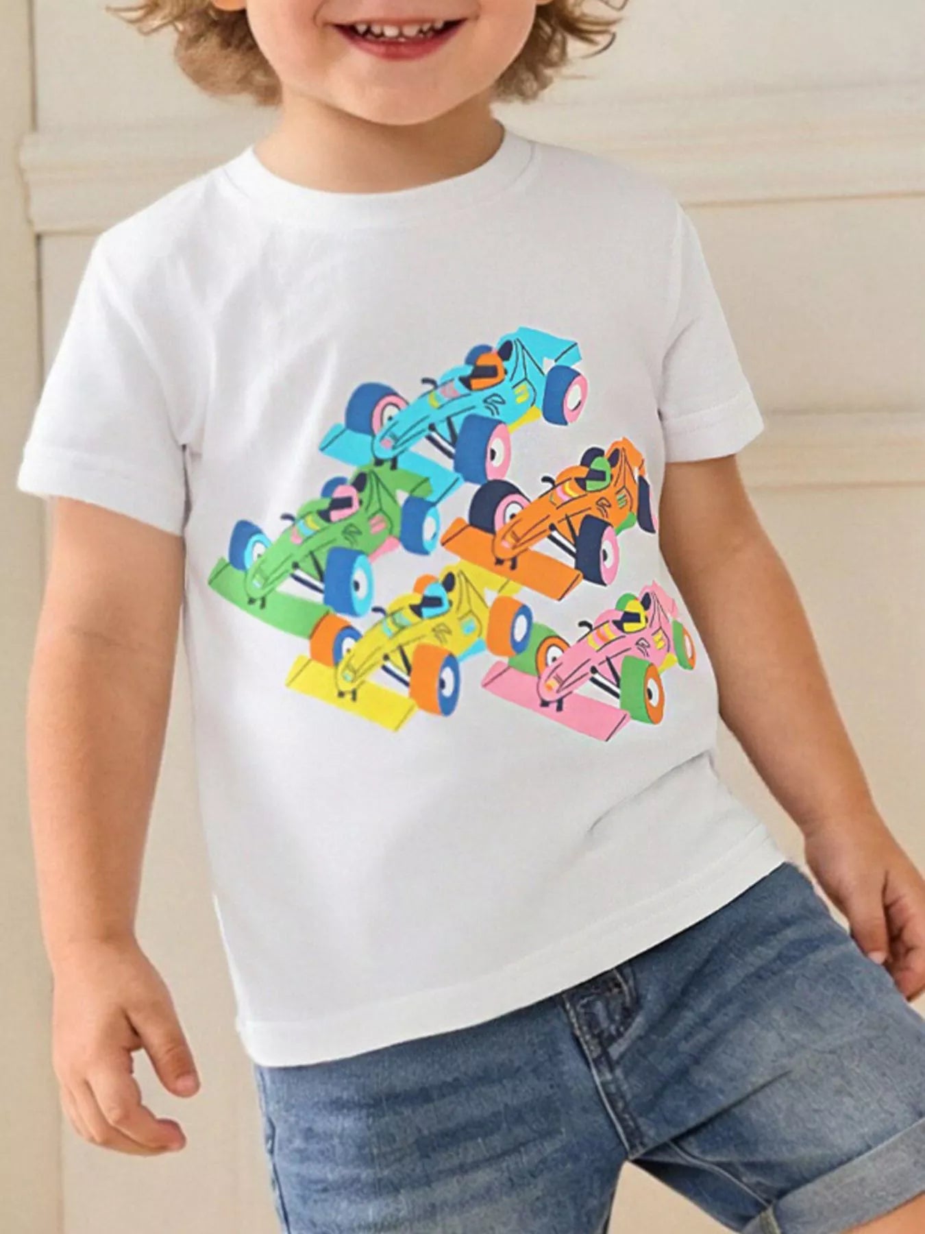 Children's white round-neck T-shirt featuring a racing car graphic.