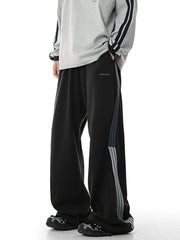Men's black relaxed-fit pants with side stripes and pockets.