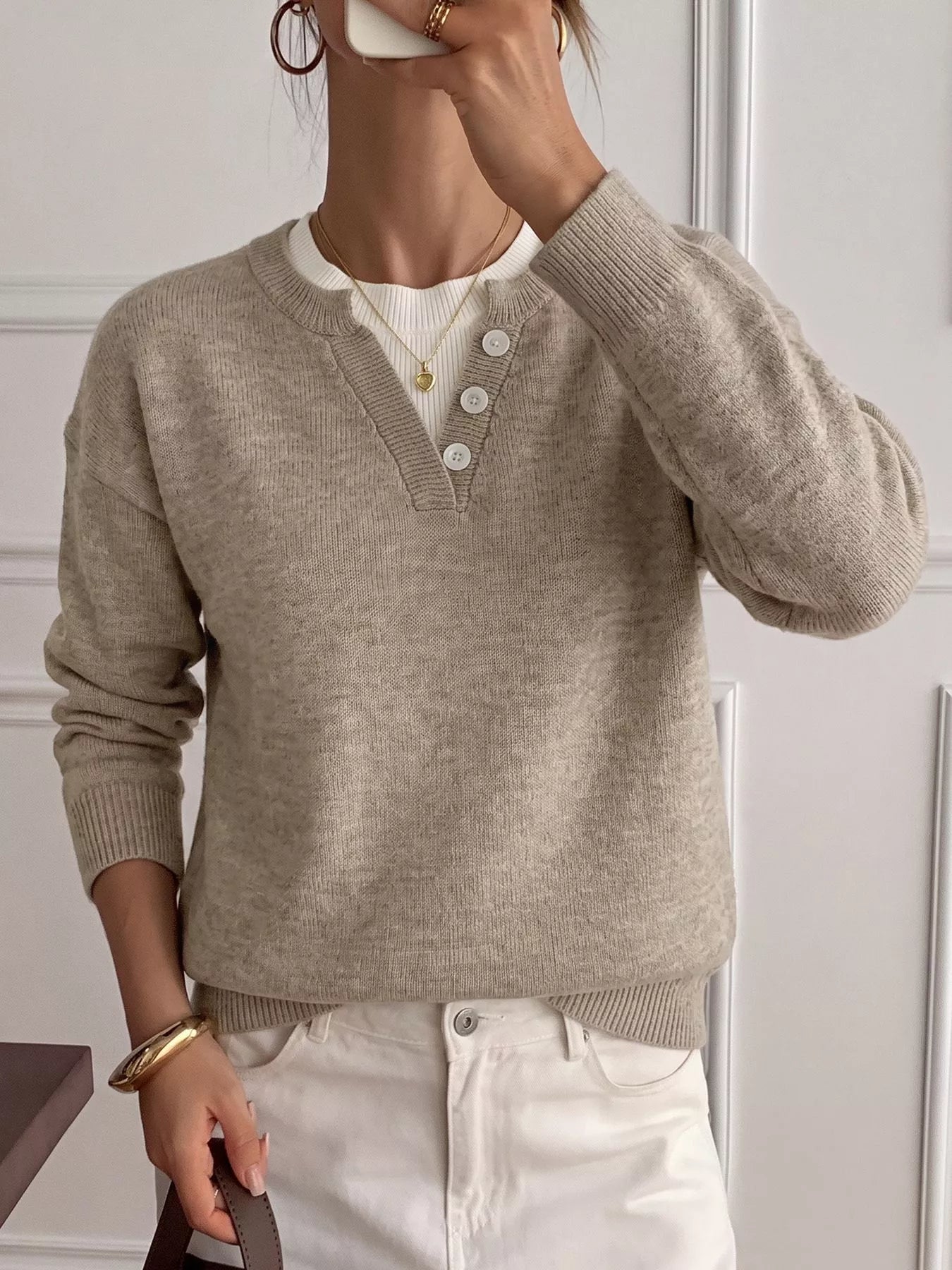 Mirror selfie view of khaki dropped shoulder sweater with V neck button placket