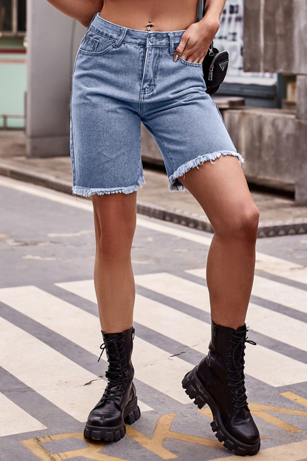 Women's denim shorts with raw hems and pockets.