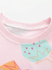 Close-up of pink children's tee neckline and mint strawberry print at chest