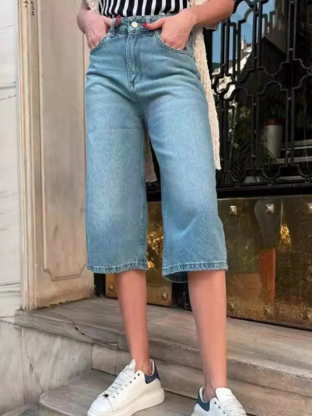 Women's high-waisted denim shorts with buttons, pockets, and a non-stretch cotton blend.