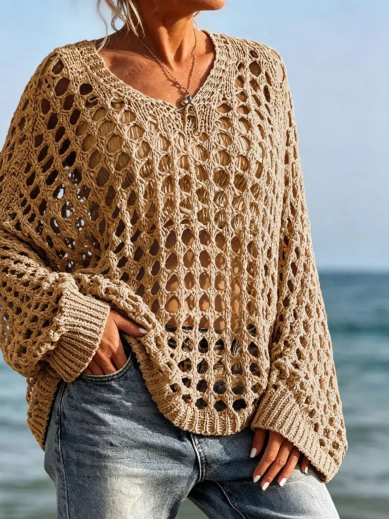 Front view of khaki openwork crochet knit cover up with V neck at the beach.