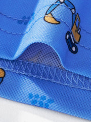 Close view of the hem stitching and excavator print detail on the blue children's polo shirt