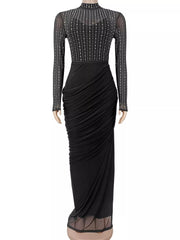 Black mock neck maxi dress with sheer rhinestone bodice and ruched skirt, front view on mannequin