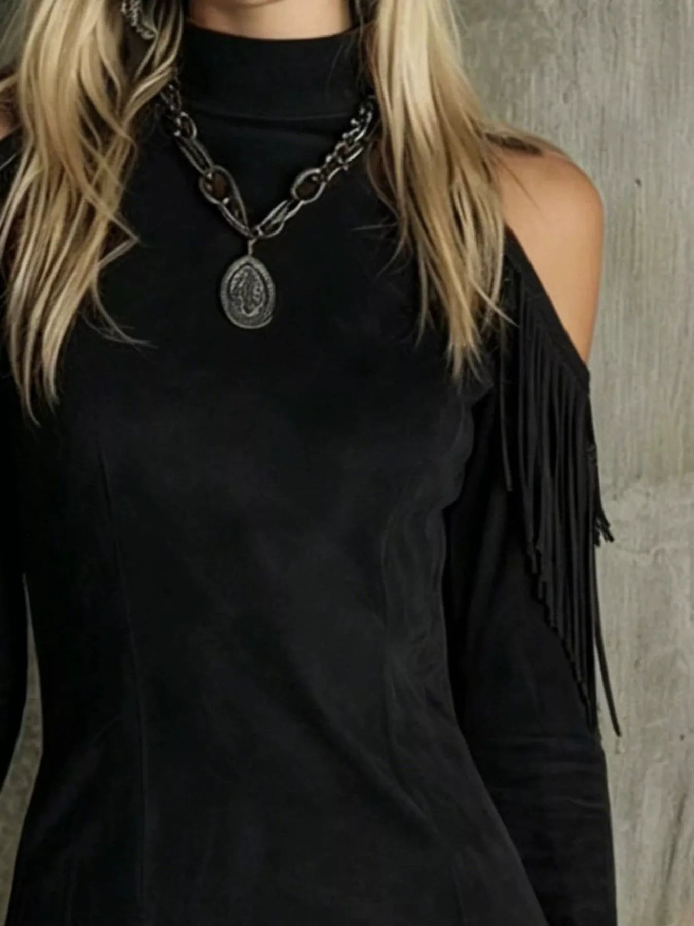 Close view of the black fringed cold shoulder mini dress bodice and shoulder fringe