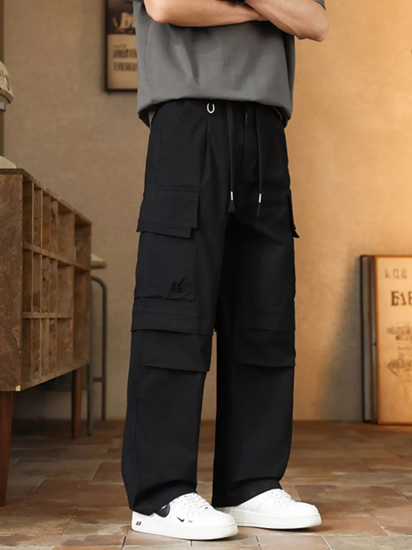 Men's relaxed fit cargo pants with a drawstring waist and pockets.