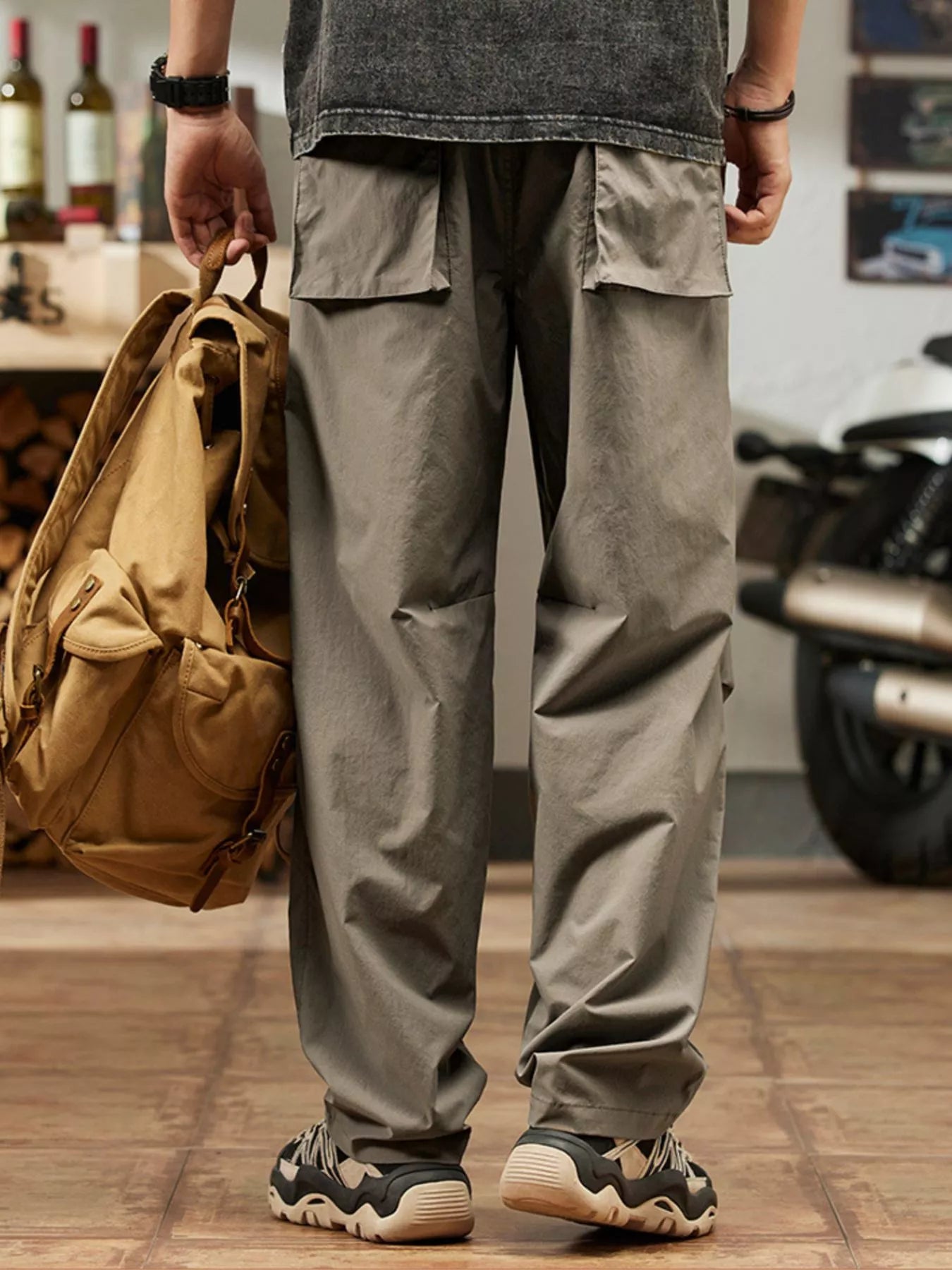 Men's khaki relaxed-fit casual pants with a drawstring waist and pockets.