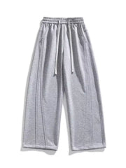 Men's light gray loose-fit wide-leg pants with a drawstring waist and pockets.
