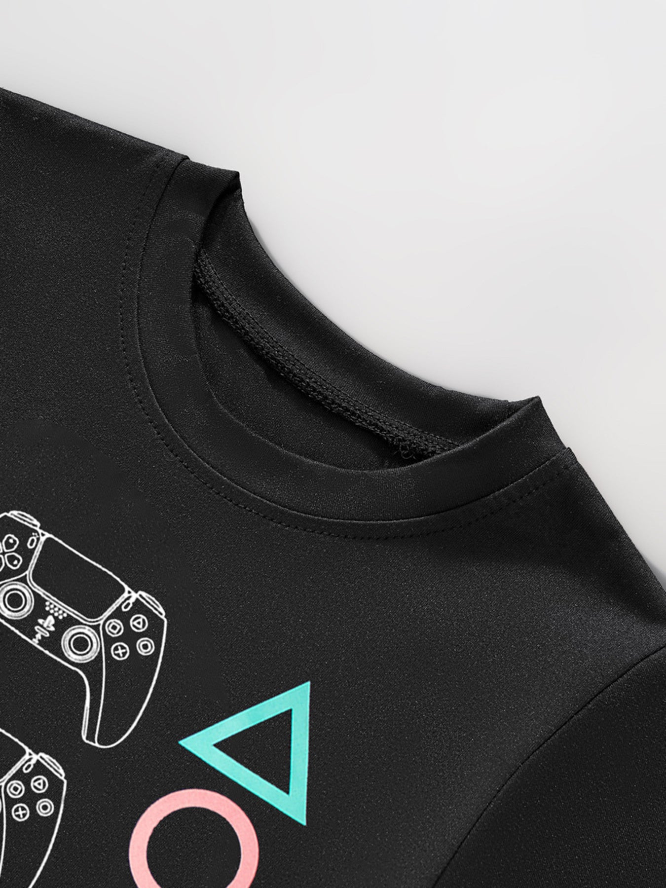 Close view of the black round neckline with the top of the controller and triangle graphics