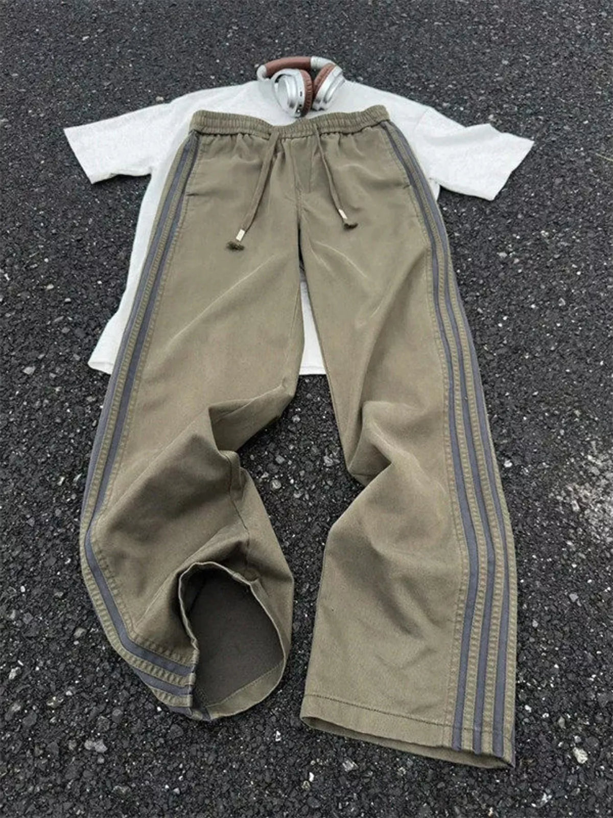 Men's striped wide leg pants with a drawstring waist and pockets.