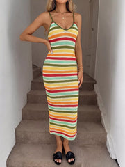 Front full view of multicolor striped bodycon knit midi dress with hand on hip